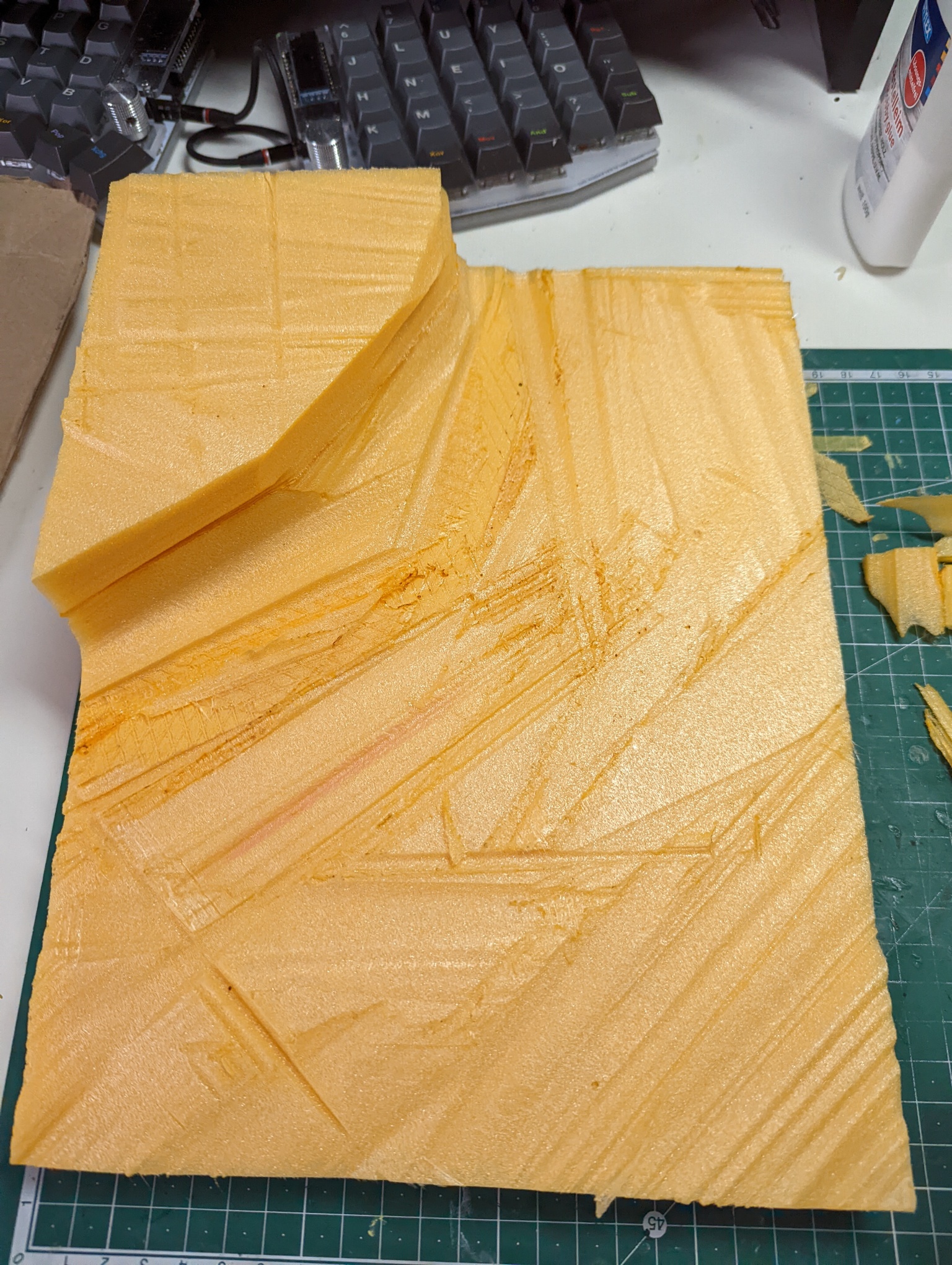 Used my hot-wire cutter to create the basic shape. I wanted to have some interesting terrain feature in the corner, something like a small cliff. I learned that using hot glue to attach the sheets of foam is not the smartest since it is much harder to cut with the hot-wire cutter.