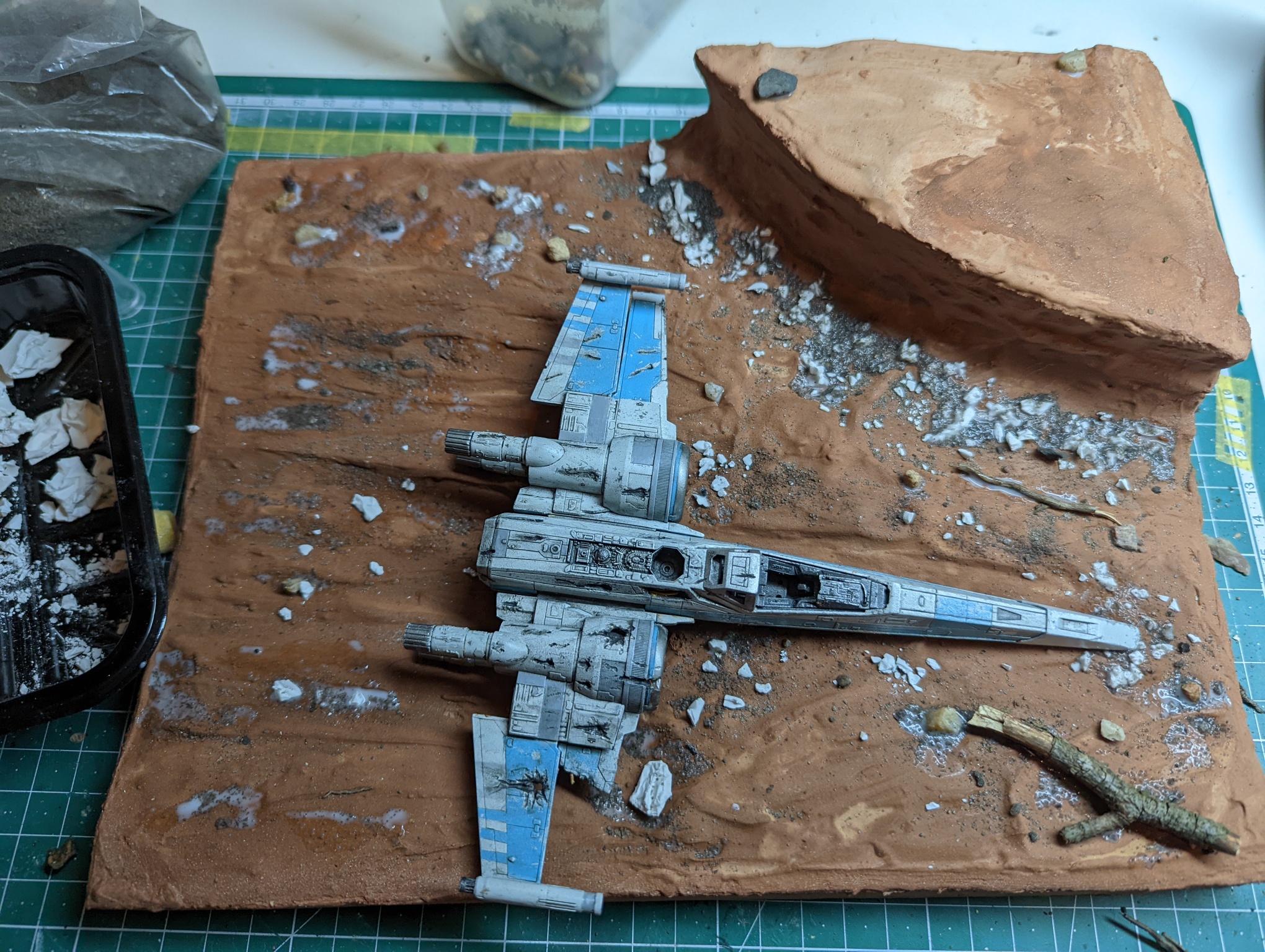 Added some sand, small stones, fragments of plaster and wood. Glued with watered-down PVA glue.
